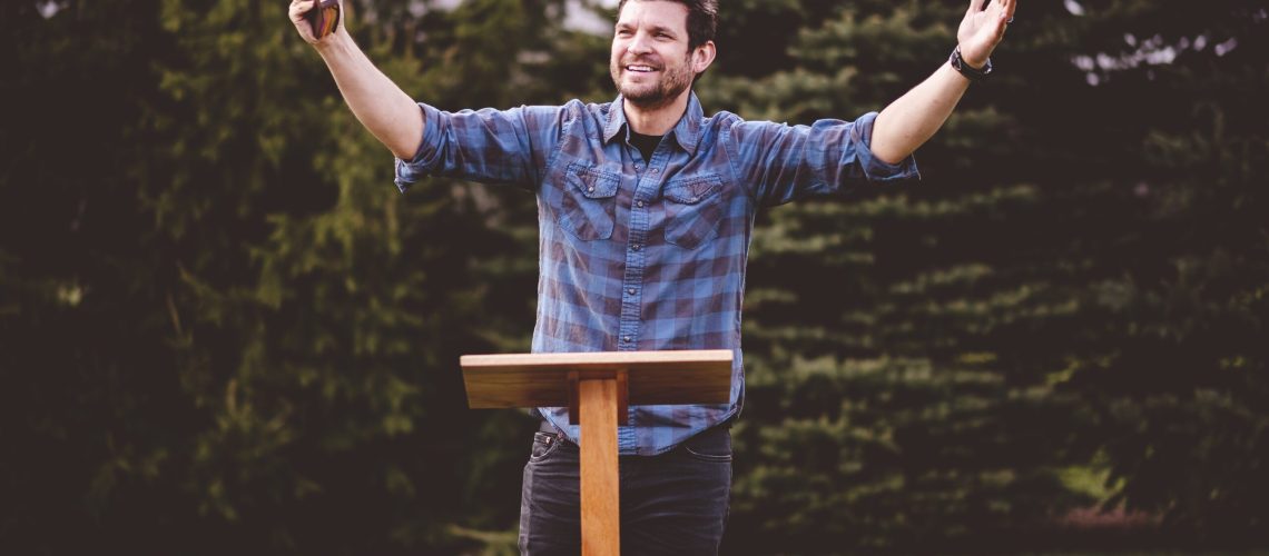A young male standing and holding the bible in his hands- perfect for oratory, speech, lecturing concepts